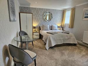 a bedroom with a bed and a glass table at The Libra in Blackpool