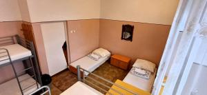 a small room with two beds and a window at Schronisko Młodzieżowe PTSM Matecznik in Przemyśl