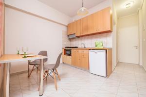 a kitchen with a table and a white refrigerator at City Life Marina apartment No. 15 in Ampavris