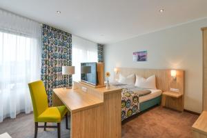 Postel nebo postele na pokoji v ubytování Ammi Hotel Garni