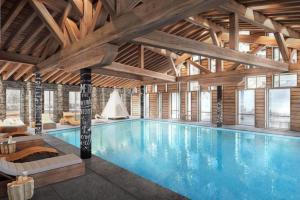 a large swimming pool in a large building at Cabana & L Altima Megeve Service in Megève