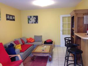 a living room with a couch and a table at Gîte Des Vergers in Illkirch-Graffenstaden