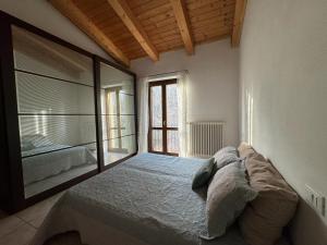 um quarto com uma cama e uma grande janela em Appartamento Matteo e Daniela em San Leo