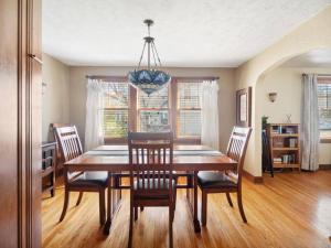 a dining room table with chairs and a chandelier at The cottage by the lake in Lakewood