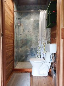 a bathroom with a toilet and a shower at Casa Sol Y Sombra in Santa Marta