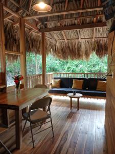 a living room with a table and a couch at Casa Sol Y Sombra in Santa Marta