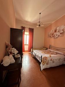 a bedroom with two beds and a window at B&B PALAZZO SASSATELLI in Cascia