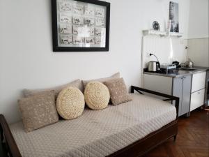 a couch with pillows on it in a room at La Petite Maison San Isidro in San Isidro