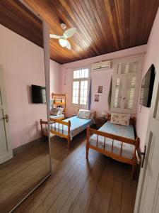 a bedroom with two beds and a mirror at Tao Station 752 in Porto Alegre