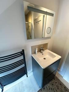 a bathroom with a sink and a mirror at Sneem Farmhouse in Sneem +52 photos
