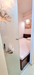 a bathroom with a shower with a bed in a room at Old town brick apartment in Krakow