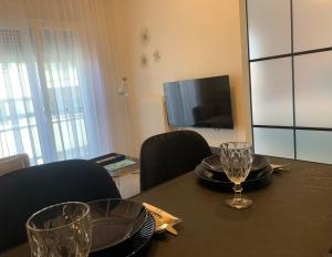 uma mesa de jantar com cadeiras e uma televisão em Casa D'oro Α2 em Lárissa