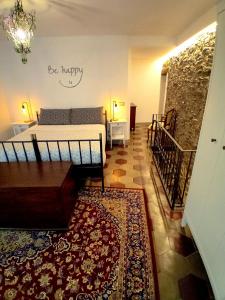 a bedroom with a bed and a table and a rug at Casa Longhi in Orta San Giulio
