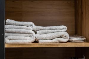 a pile of towels sitting on a shelf at Fox studio apartment in Šiauliai +11 photos