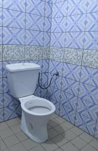 ドゥアラにあるCosy Bay 2の青いタイルのバスルーム(白いトイレ付)