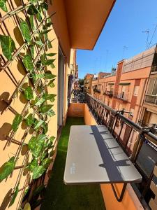 a balcony with a bench on a building at Cute and Cosy habitación privada con balcón in Valencia
