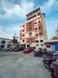 a building with motorcycles parked in a parking lot at Ratchadadome hostel in Bangkok