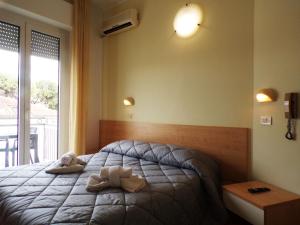 Postel nebo postele na pokoji v ubytování Hotel Frida