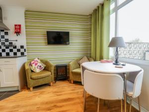 a living room with a table and chairs at Seaside Retreat in Skegness