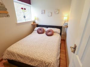 a bedroom with a bed with two pillows on it at Seaside Retreat in Skegness
