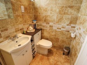 a bathroom with a toilet and a sink at Seaside Retreat in Skegness +12 photos
