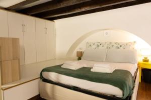 a bedroom with a large bed with green and white sheets at LaFilo Apartment 1 in Milan