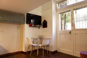 a dining room with a table and chairs and a door at LaFilo Apartment 1 in Milan