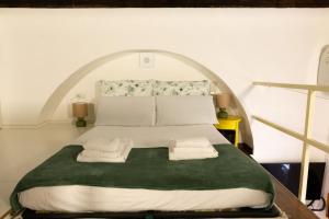 a bedroom with a bed with two towels on it at LaFilo Apartment 1 in Milan +11 photos