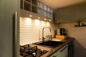 a kitchen with a sink and a stove at LaFilo Apartment 1 in Milan