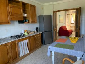 a kitchen with a refrigerator and a table in it at A casa di Zia Ale in Brindisi