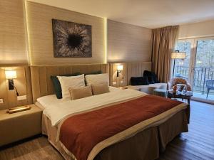 a bedroom with a large bed in a hotel room at Cocoon Hotel Belair in Bourscheid +28 photos