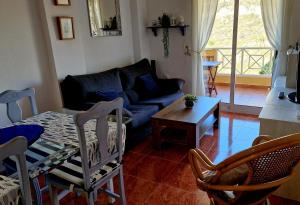 a living room with a couch and a table at Cabo de Palos Apartment in Cabo de Palos
