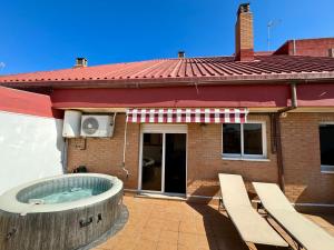 a building with a hot tub on a patio at Your Long Stay Attic Home in Valencia in Valencia