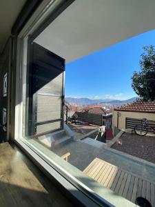a window with a view of a balcony at calm stone house elemm in Kastoria