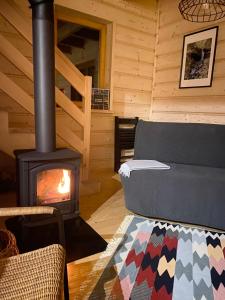 a living room with a fireplace in a log cabin at Babiogórskie klimaty in Zawoja