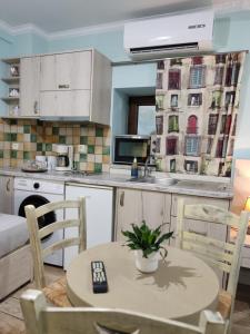 a kitchen with a table and chairs in a room at Green House Skiathos in Skiathos