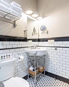 a bathroom with a sink and a toilet at Hip Urban Loft - Small Town Charm - 124 LOFTS #1 in West Dundee
