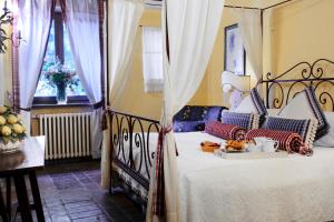 a bedroom with a bed with a tray of food on it at Locanda Del Molino in Cortona