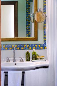 een badkamer met een wastafel en een spiegel bij Locanda Del Molino in Cortona