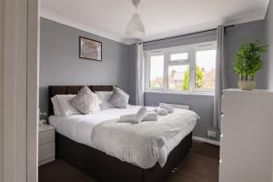 um quarto com uma cama com duas toalhas em The Kilnwood House em Crawley