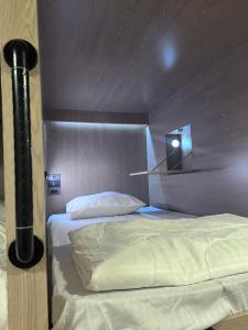 a bedroom with two beds with a wooden headboard at Ratchadadome hostel in Bangkok