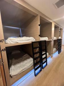 a room with two bunk beds in a room at Ratchadadome hostel in Bangkok