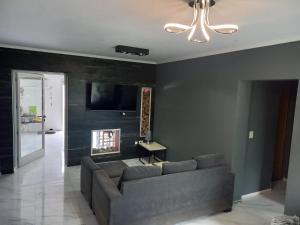 a living room with a couch and a flat screen tv at Casa en Ybarlucea para familia hasta 7 personas in Ybarlucea