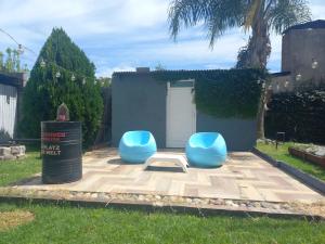 two blue chairs sitting on a patio in a yard at Casa en Ybarlucea para familia hasta 7 personas in Ybarlucea