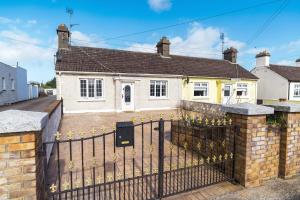 a house with a fence in front of it at Dublin Airport Homestay in Dublin
