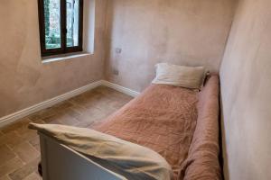 uma pequena cama num canto de um quarto em The Balcony in Tuscany em Anghiari