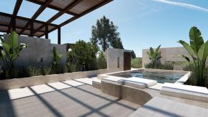 a swimming pool with two loungers on a patio at ARC suites in Ios Chora