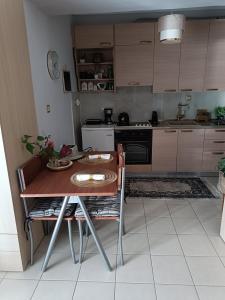 a kitchen with a table and a table and chairs at Studio Anna-Maria in Thessaloniki