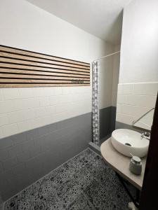 La salle de bains blanche est pourvue d'un lavabo et d'une douche. dans l'établissement Ubytování Hilšer, à Potštát