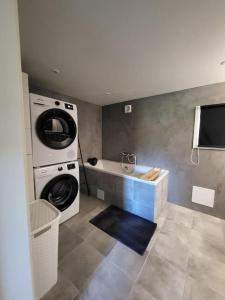 a bathroom with a washing machine and a washer at Sweet Cabin Leknes in Leknes +30 photos
